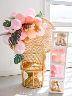 the balloon arch is decorated with pink, gold and white balloons that spell out the letter b