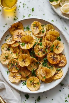 a white plate topped with sliced bananas and parsley