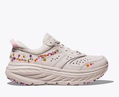 A new riff on our maximally cushioned road shoe, the Vibrant Bloom Bondi L is adapted for spring adventures with fresh pops of floral embroidery. Engineered with an early stage MetaRocker for a smooth transition through the gait cycle, this street staple features a premium nubuck upper, perforated panels, ultralight EVA midsole and marbled outsole. | Features. Floral embroidery. Marbled outsole. Nubuck leather upper. Early-stage MetaRocker geometry. Features a full-length EVA midsole. Beveled he Hoka Bondi Outfit, Hoka Outfit, Hoka Shoes Woman, Cool Running Shoes, Marathon Gear, Nimbus Cloud, 2024 Wishlist, Hoka Shoes, Colorful Sneakers