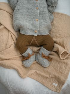 Our cosy wool booties will keep little toes toasty at all times. Crafted with beautifully soft wool. Roll-down detail around the ankle and contrast ties ensure to keep baby's feet snug and warm. They also make a lovely gift. A true staple to love and cherish! Made in Portugal from 100% of the finest Italian virgin wool yarn. Mulesing free. RWS-certified yarns (responsible wool standard) Use the size chart link above to help you find the right size. Please remember that the age information is a g Winter Playtime Booties With Soft Sole, Warm Cozy Winter Booties, Comfortable Winter Booties With Soft Sole, Cozy Fall Booties With Round Toe, Cozy Round Toe Booties For Fall, Cozy Winter Booties With Soft Sole, Brown Winter Booties With Soft Sole, Winter Brown Booties With Soft Sole, Cozy Brown Winter Booties