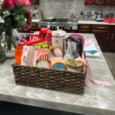 a wicker basket filled with personal care items on a kitchen counter next to flowers