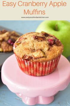 an easy cranberry apple muffin on a pink plate