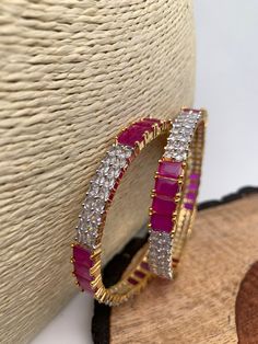 Ameriacan Diamond Ruby Red Bangles. It comes as a Pair (2 Bangles). Premium quality and craftmanship. Satisfaction Guaranteed. Please measure your size before ordering as we don't accept returns. Starting size we have is 2.4. We don't carry size 2.2. Pink Ruby Round Bracelets, Red Hoop Jewelry For Festive Occasions, Red Hoop Jewelry For Wedding, Festive Red Hoop Jewelry, Red Ruby Bangle As Gift, Pink Ruby Bracelets As Gift, Handmade Red Ruby Bracelets, Ruby Bangle As A Gift, Red Ruby Bracelet For Festive Occasions