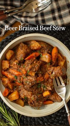 beef and carrot stew in a white bowl with a fork on the side next to it