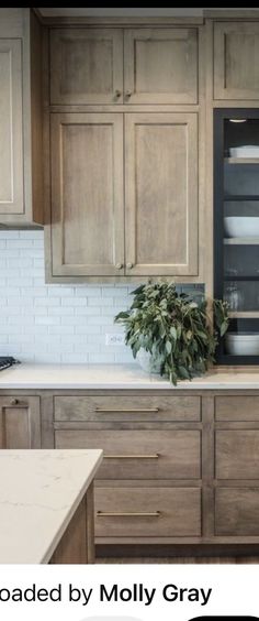 an image of a kitchen setting with wooden cabinets and white counter tops in the background