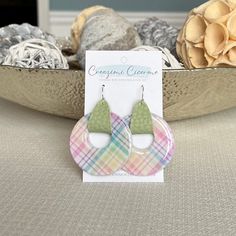 "These unique and fun spring plaid earrings are lightweight, featuring pearly white clay decorated with a pastel plaid design. Faux/vegan leather straps are threaded through the donut shaped clay pendants and used to attach them to earring wires. Clay is carefully hand mixed, decorated, molded, baked, sanded and sealed with high gloss resin before assembly. All creations are carefully crafted by hand, therefore no two items are identical. Slight variations in plaid patterns are to be expected. E Spring Casual Hypoallergenic Jewelry, Casual Hypoallergenic Jewelry For Spring, Casual Hypoallergenic Spring Jewelry, Trendy Circle Earrings For Spring, Casual Everyday Spring Jewelry, Casual Small Hoop Earrings For Gifts, Everyday Green Jewelry For Spring, Everyday Multicolor Spring Earrings, Handmade Pastel Jewelry For Spring