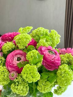 a vase filled with pink and green flowers