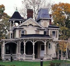 an old victorian style house in the fall