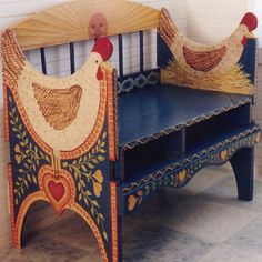 two chickens sitting on top of a bench