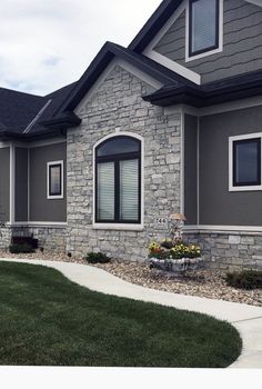 a gray house with black roof and windows