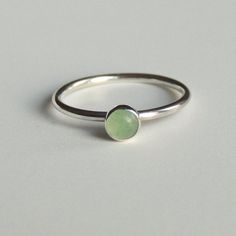 A petite, 4mm green aventurine cabochon has been bezel set in a handmade ring of sterling silver. Perfect on its own or as an addition to your favourite stacking rings. So cute as a midi ring! The most common midi ring (above the knuckle ring) sizes are 3, 3.5 and 4. The final Aventurine Engagement Ring, Coral Costume, Ring Green Stone, Aventurine Ring, Gemstone Stacking Ring, Green Stone Ring, Jewellery Diamond, Handmade Gold Jewellery, Green Ring