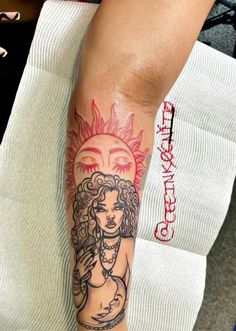 a woman with a sun tattoo on her arm