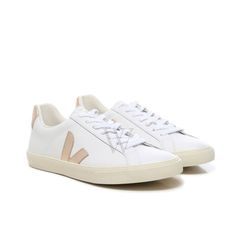 Veja Ladies Sneakers. SKU: EO0202490. Color: Extra/White Platine. Veja Esplar Logo Womens Sneakers. This sneakers feature a flat laces crafted from organic cotton at the front, complemented by a color-matching leather tongue adorned with the Veja logo print. On both sides, the shoes showcase the iconic "V" in glitter-finish. They are equipped with an Amazonian natural rubber sole, a padded ankle collar for added comfort, and a reinforced back patch with a contrasting signature leather insert. The interior includes a textile lining and insole for enhanced wearability. Please visit the brand website for sizing information. Everyday Lace-up Sneakers For Spring, White Canvas Shoes With Rubber Sole For Everyday, White Vulcanized Sole Sneakers For Everyday, Everyday White Vulcanized Sole Sneakers, White Round Toe Canvas Shoes For Everyday, Spring Low-top Sneakers With White Laces, Comfortable White Canvas Shoes With Laces, White Canvas Shoes With Round Toe For Everyday, White Canvas Shoes With Round Toe