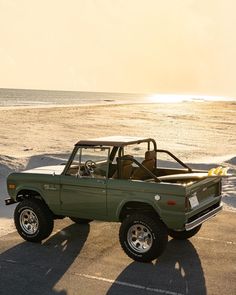 an old pick up truck parked on the beach