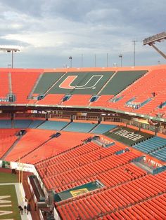 an empty stadium filled with lots of orange seats