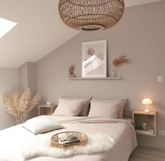 a bedroom with a wicker basket hanging from the ceiling and bed in front of it