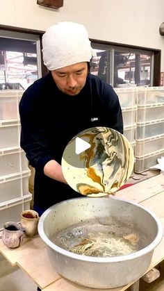 a man is mixing something in a bowl