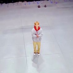 a young man standing on top of an ice rink