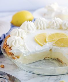 a lemon pie with white frosting and sliced lemons