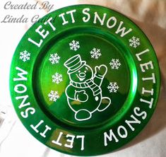 a green plate that says let it snow, let it monsist on the front