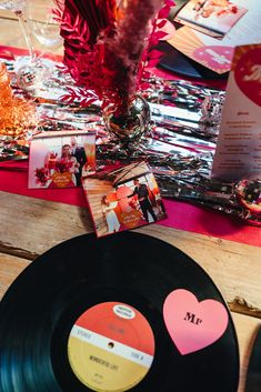 the table is set up with an old record and other personalized items for guests