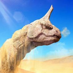 an image of a dinosaur head in the desert with sand blowing up from it's mouth