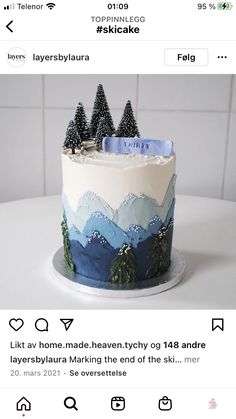 the cake is decorated with mountains and trees