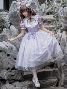 This enchanting piece features a delicate lilac print that exudes a soft, romantic aura, perfect for any Lolita enthusiast. The overlay hem adds a touch of whimsy and layered sophistication, with a removable bowknot on the waist, allowing for customizable styling to suit your preference.  SizeSMLFull Length109112115Shoulders3335.537Bust818691Waist636873Hem Circumference270275280Neck Circumference35.53738.5Sleeve Length212223 Purple Fairycore Dress With Ruffles, Spring Balletcore Dresses With Lace Trim, Feminine Lavender Dress For Garden Party, Purple Short Sleeve Dress With Lace Trim, Feminine Purple Dress For Garden Party, Purple Lace Trim Dress For Spring, Spring Purple Dress With Lace Trim, Steampunk Fashion Female, Steampunk Fashion Male