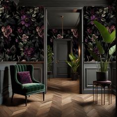 a green chair sitting in front of a wall with flowers on it