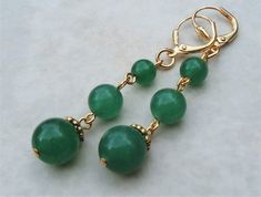 "This simple yet elegant pair of earrings features three emerald green jade gemstones. Hanging from a surgical steel lever-back, it measures 2.5\" in length. Earrings are light weight and sway gracefully as you move about your day. These beautiful dangle earrings are unique, feminine and eye-catching, a great accent to any wardrobe. Also available in sterling silver plate. Available with sculpted clip-on earrings top, please see last photo." Bridal Clip, Dangle Earrings Gold, Green Jade, Gold Earrings Dangle, Gift Handmade, Jade Green, Earrings Gold, Beautiful Earrings, Emerald Green