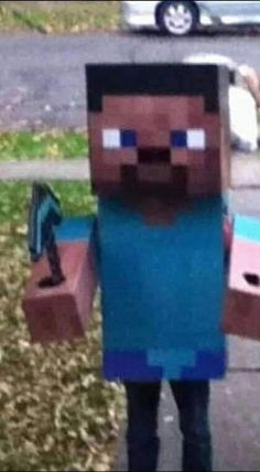 a man in a costume made to look like a minecraft character standing on the sidewalk