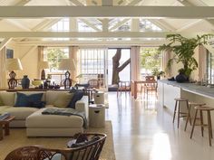 a living room filled with furniture and lots of windows