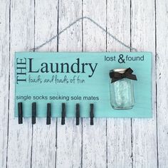 a sign hanging on the side of a wooden wall that says, the laundry look and loads of fun