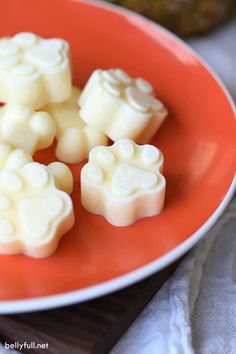 several pieces of white chocolate on an orange plate