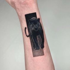 a black cat tattoo on the wrist