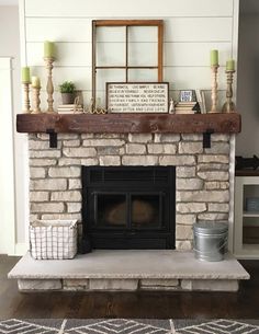 a fireplace with some candles and other items on top of it, in a living room