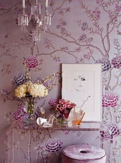 an image of a room with wallpaper and flowers on the shelf next to it