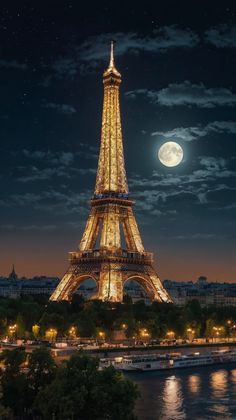 the eiffel tower lit up at night in paris, france with full moon