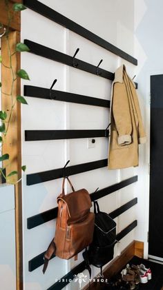 there is a coat rack on the wall with shoes and backpacks hanging from it