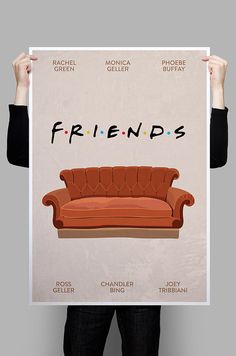 a person holding up a poster with a couch in front of them that says friends