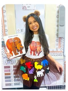 a woman holding up a book in front of a bear and bear print t - shirt