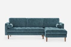 a blue couch sitting next to a white wall