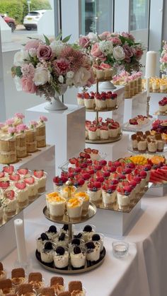 an assortment of desserts are displayed on a table