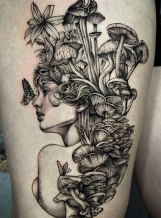 a woman's thigh with mushrooms and butterflies on it, in black and white