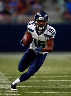 a football player is running with the ball