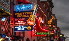 neon signs on the side of buildings in an urban area