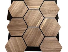 the wooden hexagonal tiles are arranged on top of black and white wood planks