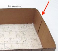 an open cardboard box with a map on it and arrows pointing in opposite directions to the bottom