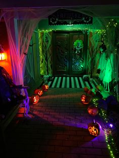 halloween decorations are lit up in front of a house