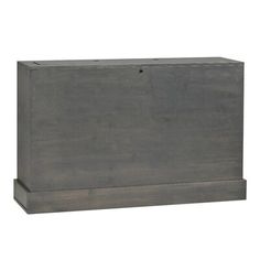 a large wooden box sitting on top of a white wall